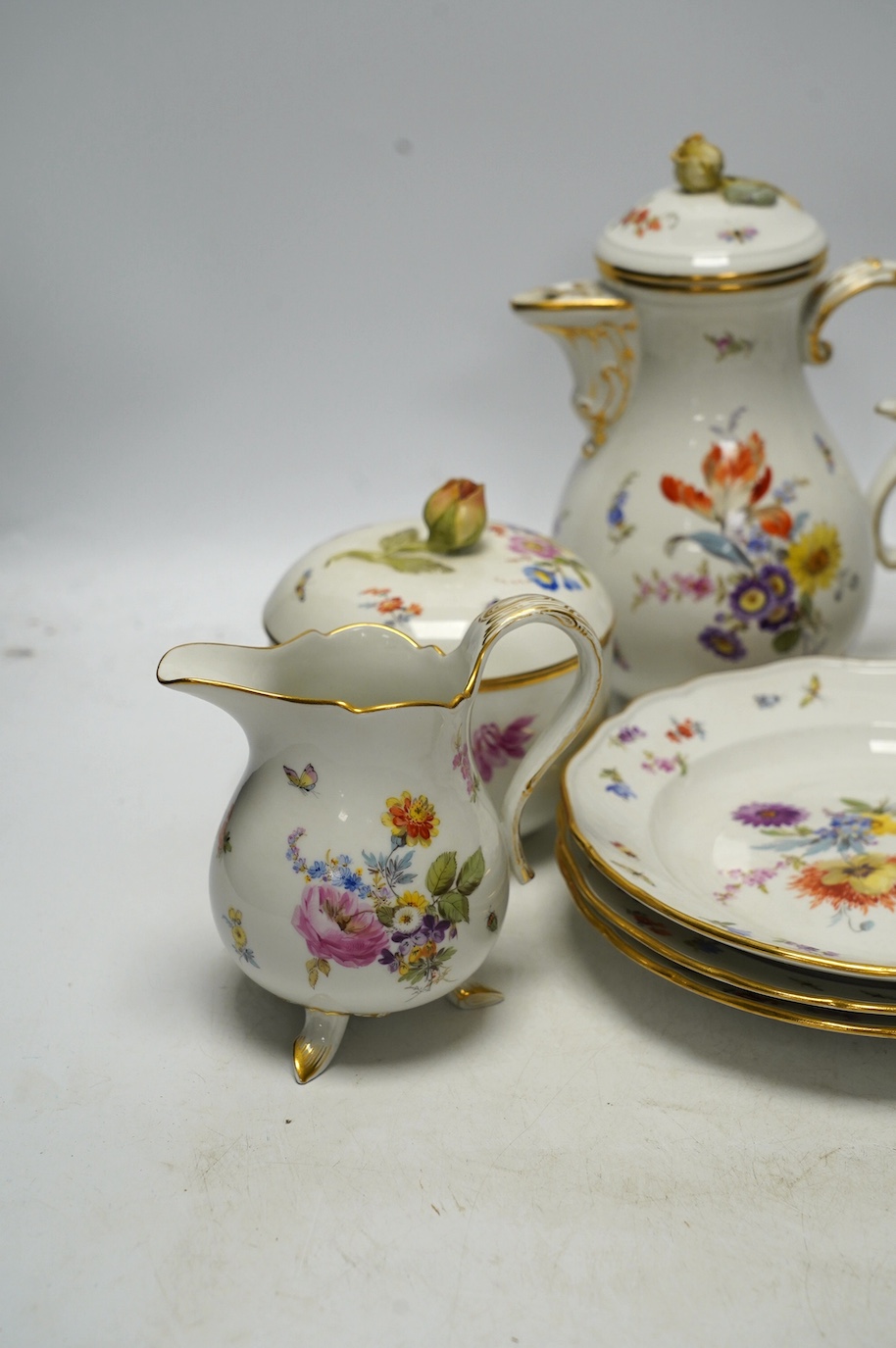 An early 20th century Meissen porcelain teaset, painted with insect and floral decoration, tallest 20cm. Condition - fair to good